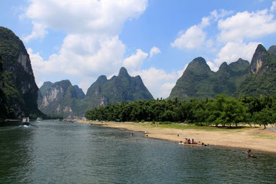 Panoramic view of sea and mountains against sky