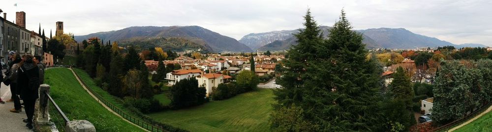 Panoramic view of people on mountain against sky