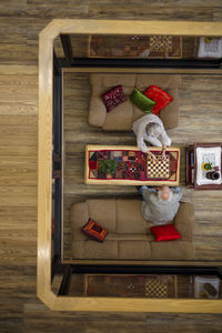 Senior man and woman playing chess in retirement home