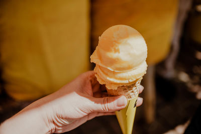 Close-up of hand holding ice cream