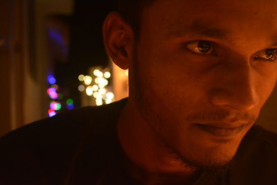 Close-up portrait of young man at home