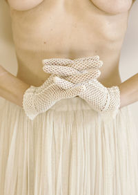 Woman with crochet gloves and beige tulle skirt