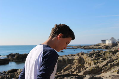 Man at beach against sky