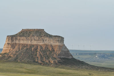 View of rock formation on land against clear sky