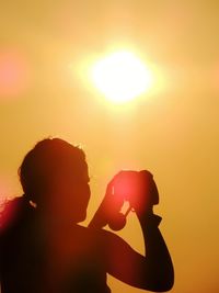 Silhouette of woman at sunset