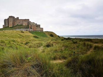 Castle by sea against sky. bamburgh castle. northumberland. uk