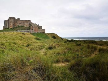 Castle by sea against sky