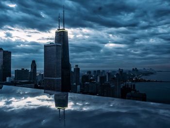 City skyline against cloudy sky