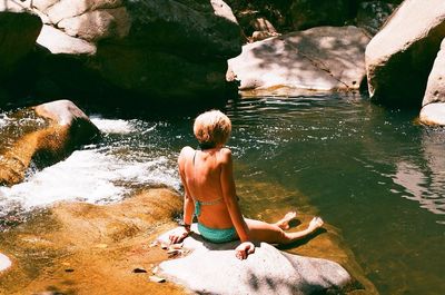 Woman sitting on rock