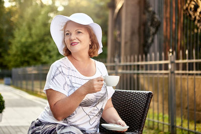 Portrait of woman holding coffee cup