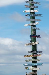 Low angle view of information signs against sky