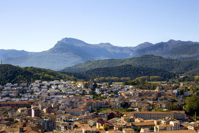 High angle view of houses in town against clear sky