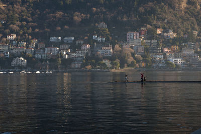 People on river by city