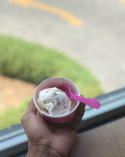 Close-up of hand holding ice cream