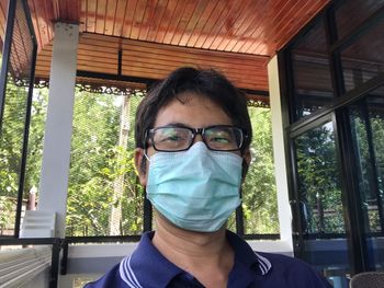 Portrait of man wearing sunglasses against trees