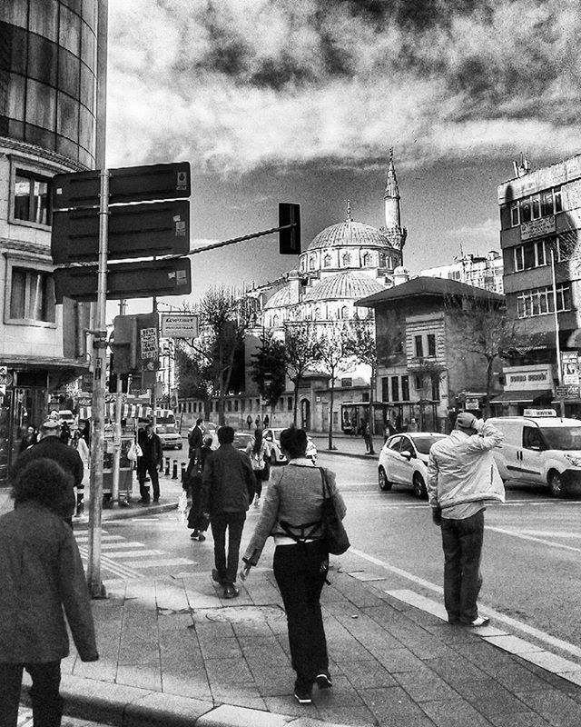 building exterior, architecture, built structure, men, city, large group of people, person, street, sky, walking, lifestyles, city life, cloud - sky, leisure activity, rear view, city street, road, zebra crossing, building