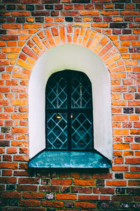 Close-up of window on brick wall