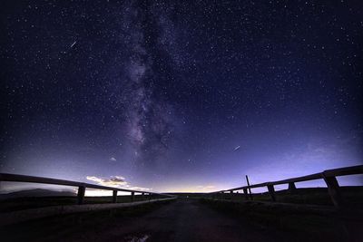 Road against sky at night