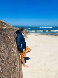 Rear view of man standing on beach