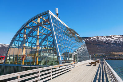 Low angle view of bridge against clear blue sky