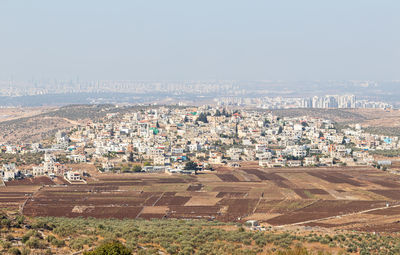 High angle view of buildings in city against sky