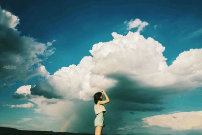 Woman photographing smoke against sky