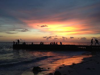 People on beach at sunset