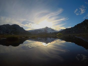 Scenic view of lake and mountains against sky