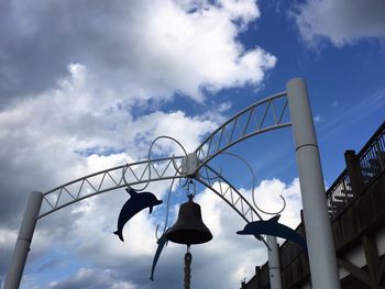 Low angle view of street light against cloudy sky