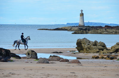 People on beach by sea