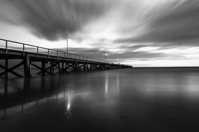 Low angle view of bridge over calm sea