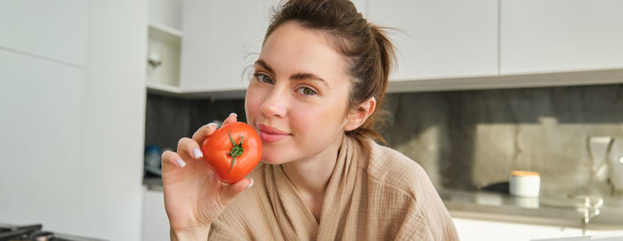 Side view of young woman eating fruit