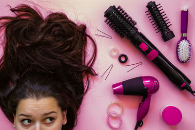 Woman with brown hair by personal accessories on table