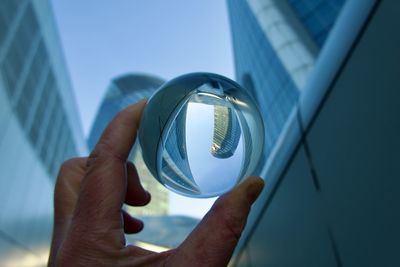 Cropped hand holding crystal ball