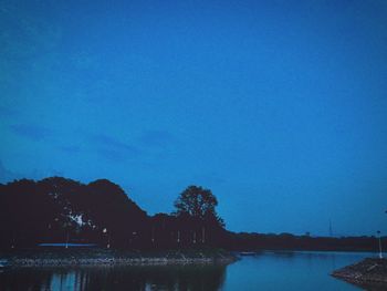 Scenic view of lake against clear blue sky