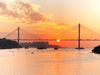 Ting kau bridge over river against sky during sunset