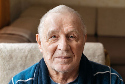 Close up portrait of old smiling man looking at camera