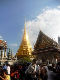 People at temple against sky