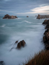 Rocks in sea against sky