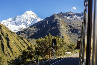 Road by mountains against clear sky