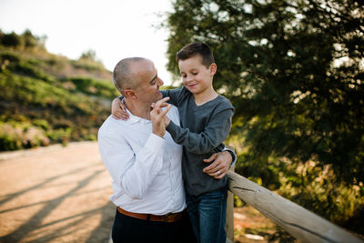 Father and son embrace and smiling in southern california