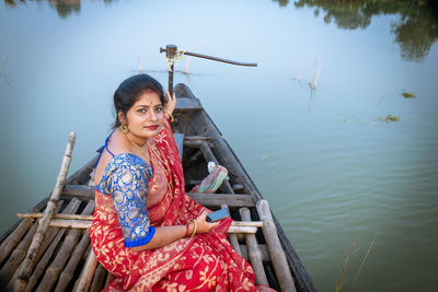 Portrait of young woman sitting on boat