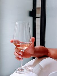 Hand holding glass of wine