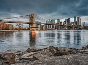View of bridge over river against cloudy sky