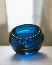 Close-up of blue glass on table