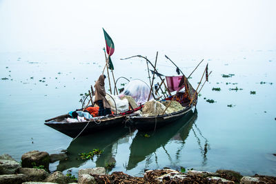 Fisherman taking preparation for fishing in the foggy winter morning. 