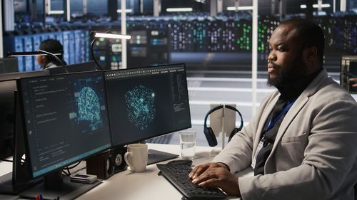 Side view of young man working on table