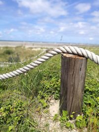 Close-up of rope on field against sky