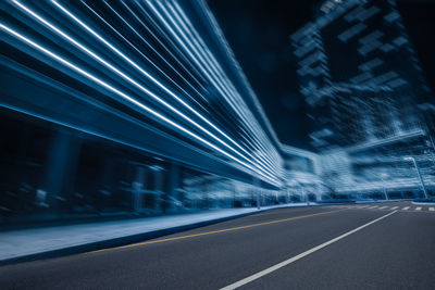 Light trails on road in city at night