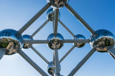 Low angle view of metallic structure against clear blue sky